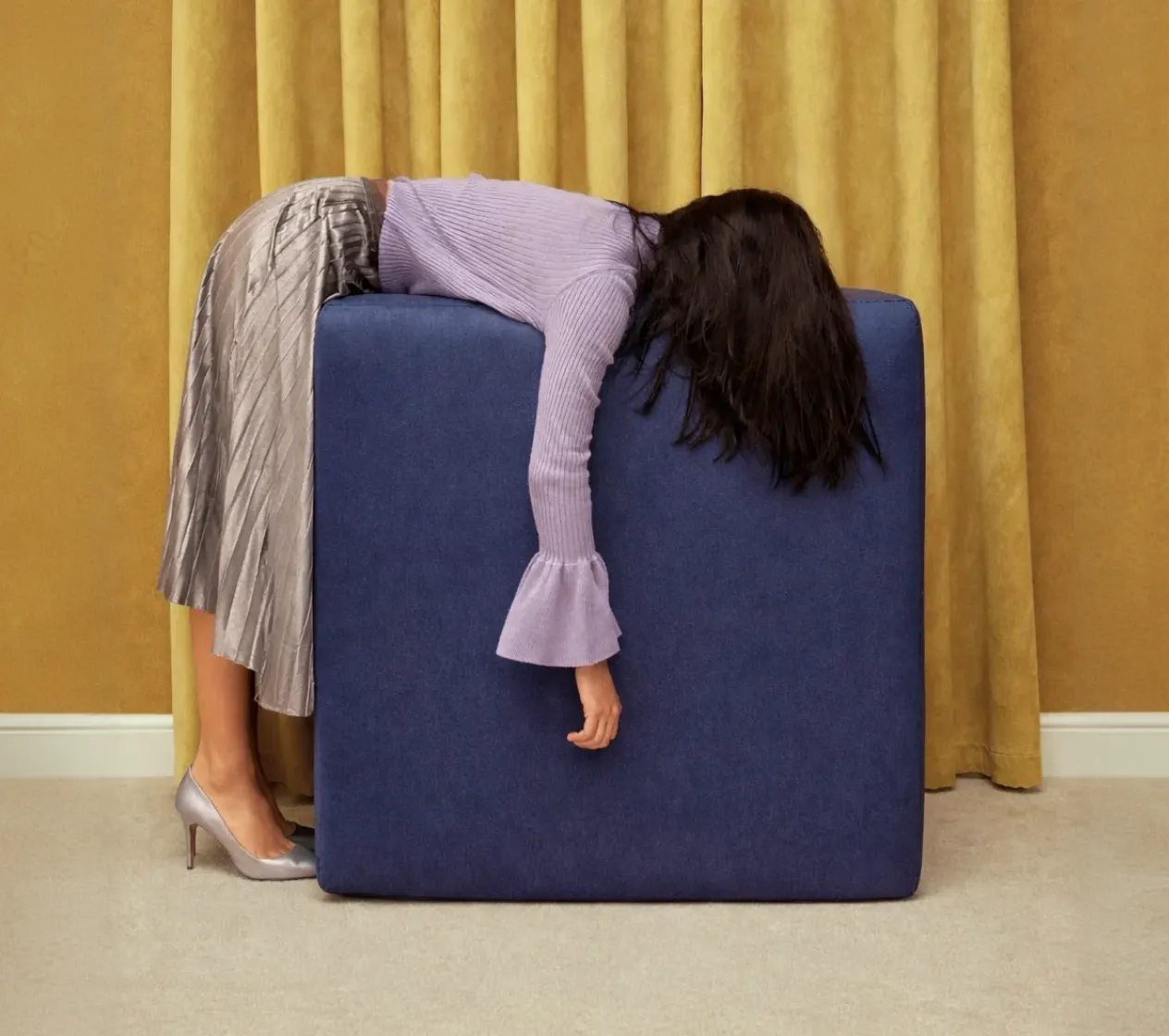 Professional woman laying on a box